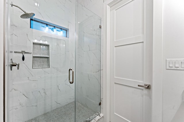 bathroom featuring a marble finish shower