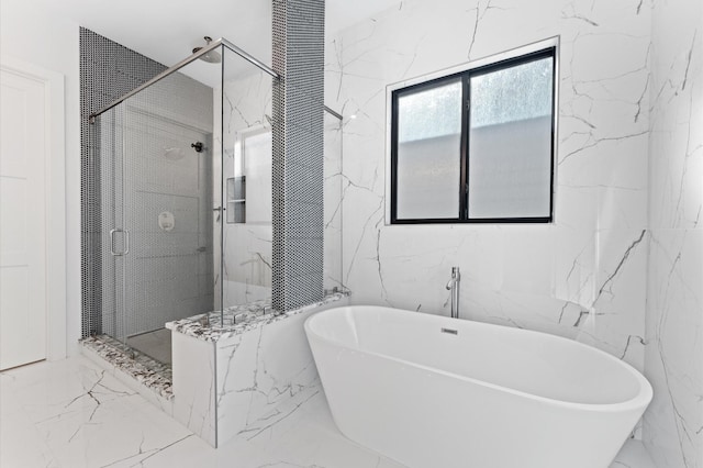 bathroom featuring a soaking tub, marble finish floor, stone wall, and a shower stall