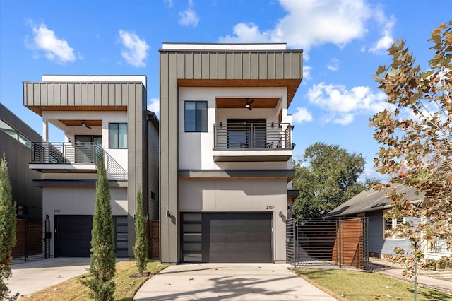 contemporary home featuring a balcony, driveway, a ceiling fan, and a garage