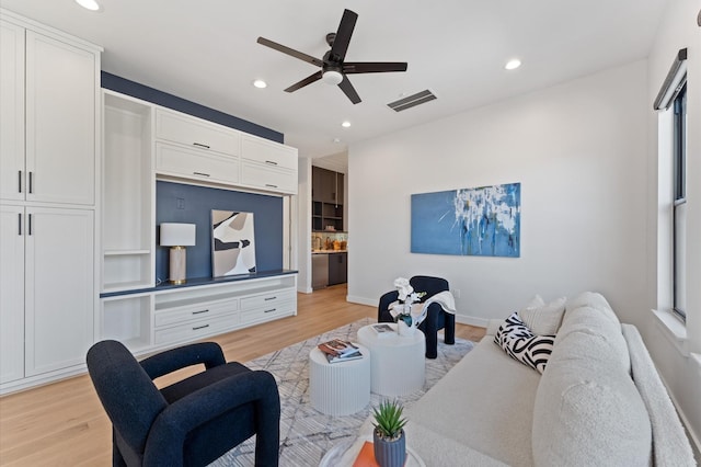 living area featuring recessed lighting, visible vents, and light wood finished floors