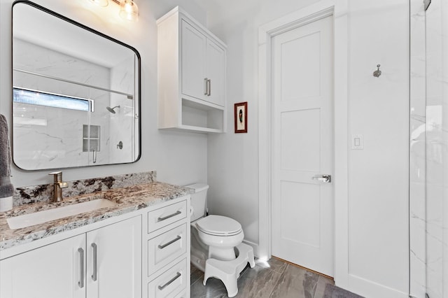 full bathroom with vanity, toilet, and a marble finish shower