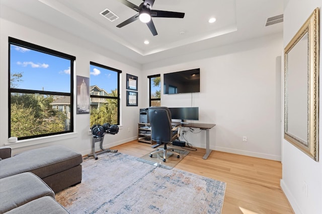 office space featuring baseboards, visible vents, and light wood-type flooring