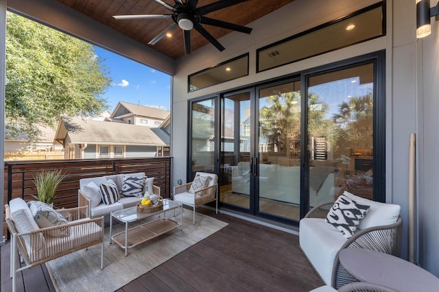 wooden terrace featuring ceiling fan and an outdoor hangout area