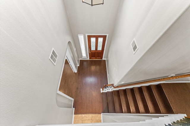 entryway featuring visible vents, stairway, and wood finished floors