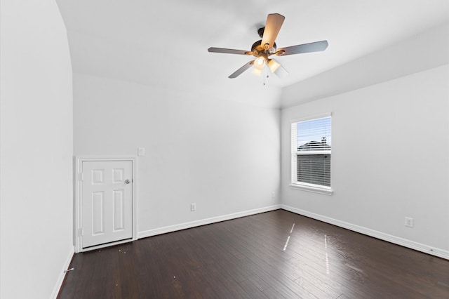 spare room with dark wood-type flooring, baseboards, and a ceiling fan