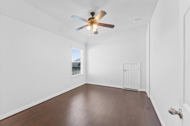 unfurnished room featuring vaulted ceiling, dark wood-style flooring, ceiling fan, and baseboards