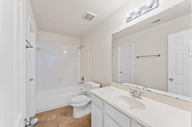 bathroom with visible vents, vanity, toilet, and tile patterned floors