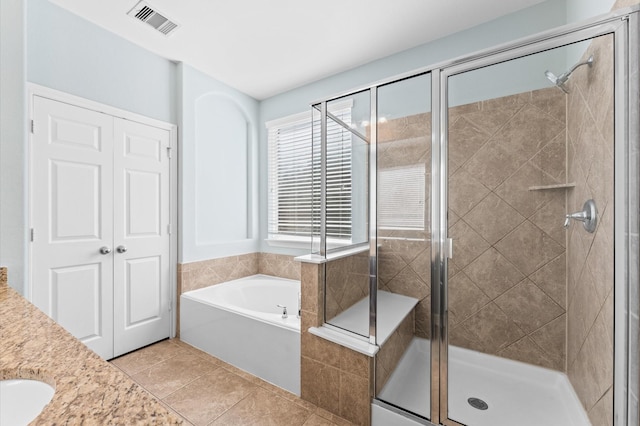 full bathroom with tile patterned floors, visible vents, a shower stall, and a bath