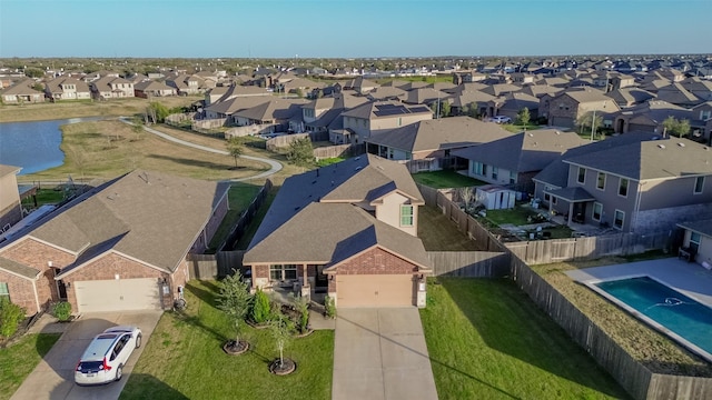 bird's eye view featuring a water view and a residential view