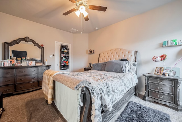 bedroom with a closet, carpet flooring, ceiling fan, and visible vents