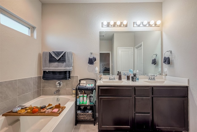 bathroom featuring double vanity, a sink, and a bath