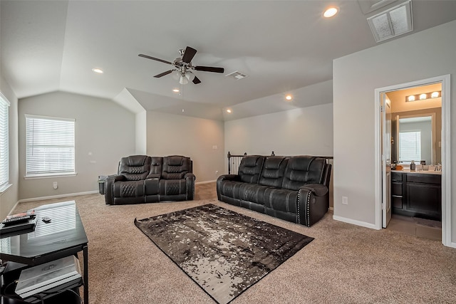 living area featuring light colored carpet, visible vents, lofted ceiling, and recessed lighting