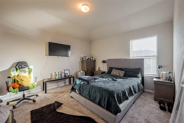 bedroom featuring carpet, lofted ceiling, and baseboards