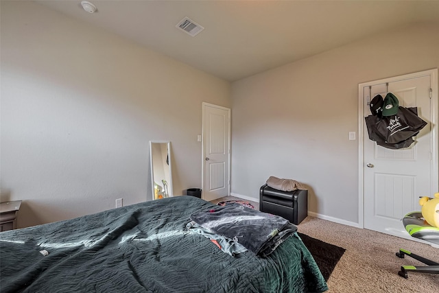 carpeted bedroom featuring visible vents and baseboards