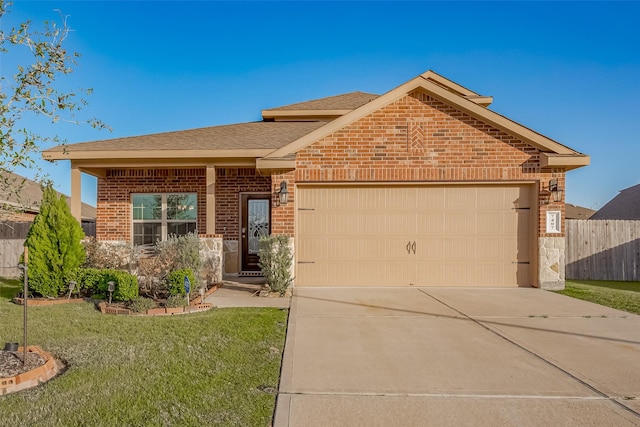 view of front of house with an attached garage, brick siding, fence, driveway, and a front lawn