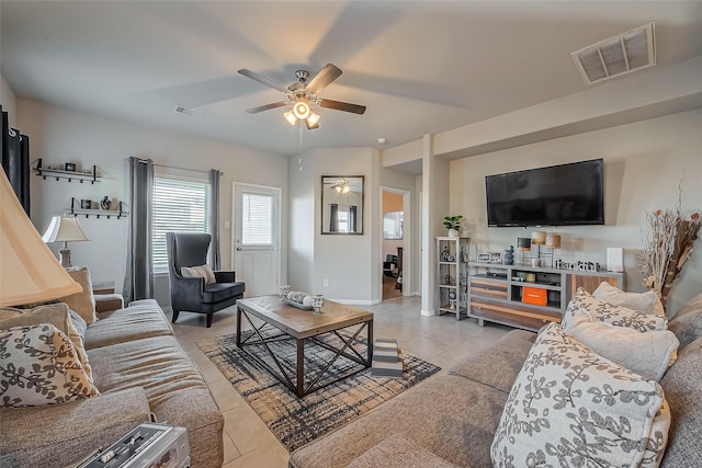 living room with light tile patterned floors, ceiling fan, and visible vents