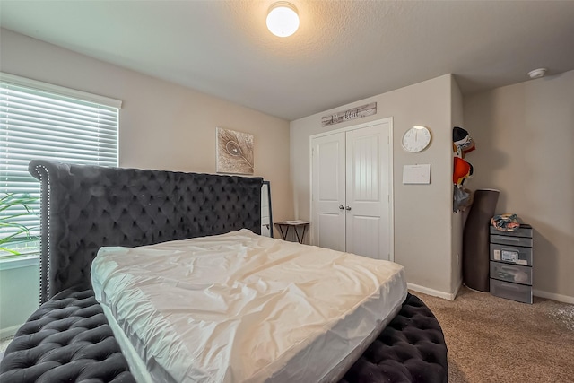 bedroom featuring a closet, light colored carpet, and baseboards