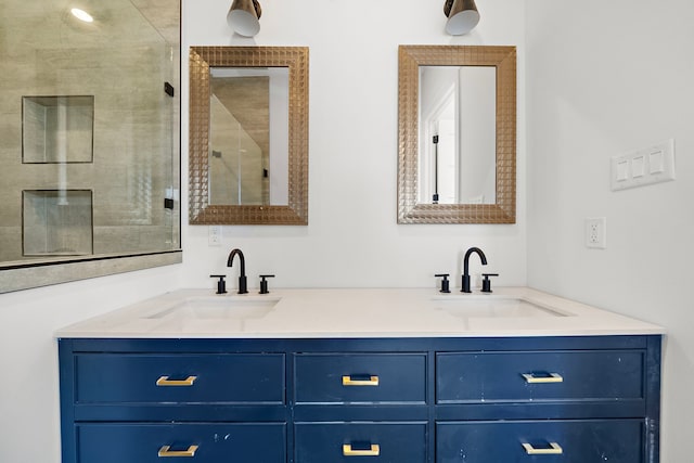 full bath featuring an enclosed shower, a sink, and double vanity