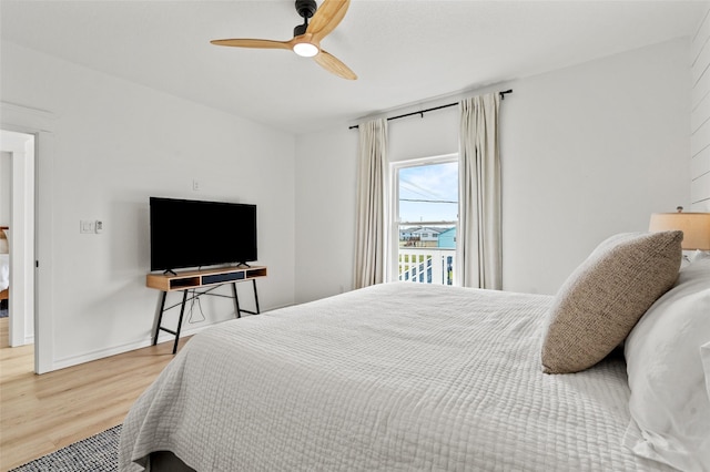 4214 Jackson Dr, Galveston, TX 77554 - bedroom featuring wood finished floors, a ceiling fan, and baseboards