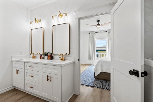 4214 Jackson Dr, Galveston, TX 77554 - bathroom featuring double vanity, wood finished floors, and a sink