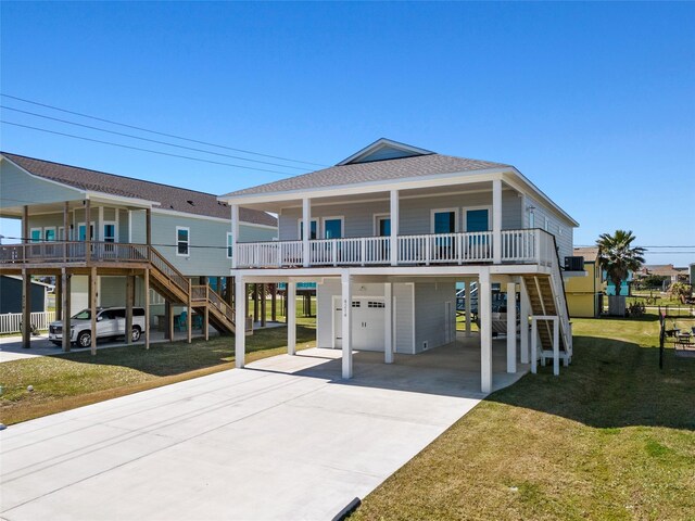 4214 Jackson Dr, Galveston, TX 77554 - coastal home with driveway, stairway, roof with shingles, a carport, and a front yard