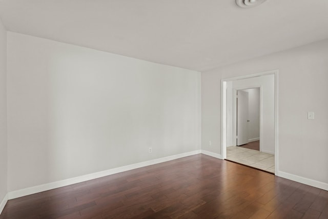 unfurnished room featuring baseboards and wood finished floors