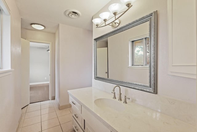 bathroom with tile patterned flooring, vanity, and baseboards