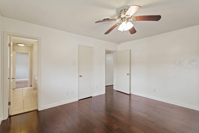 unfurnished bedroom with a ceiling fan, baseboards, and wood finished floors