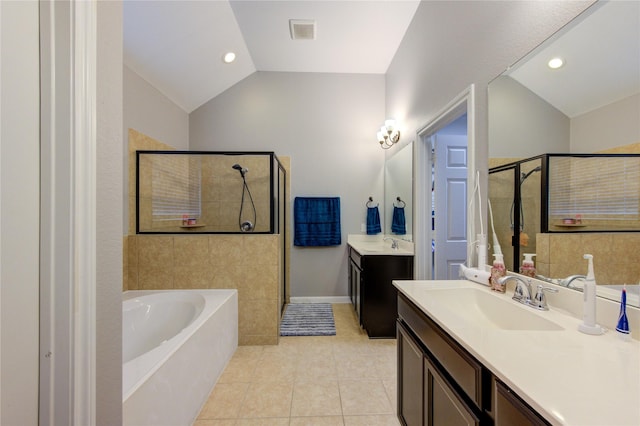 bathroom with tile patterned flooring, a garden tub, a sink, vaulted ceiling, and a shower stall