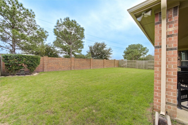 view of yard with a fenced backyard