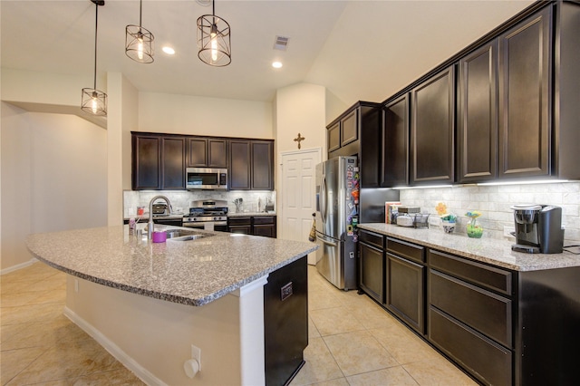 kitchen featuring tasteful backsplash, visible vents, appliances with stainless steel finishes, light tile patterned flooring, and a sink