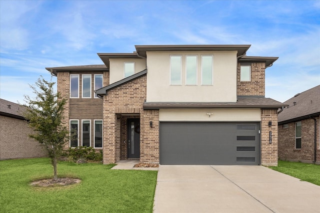 view of front of home featuring an attached garage, brick siding, driveway, stucco siding, and a front yard