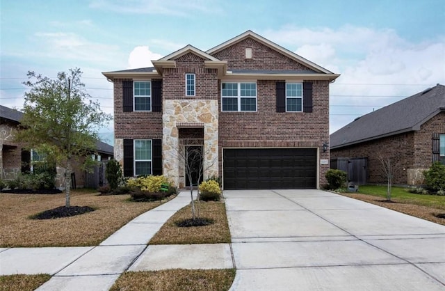 traditional home featuring an attached garage, brick siding, stone siding, concrete driveway, and a front lawn