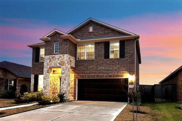 view of front of home with a garage, stone siding, brick siding, and concrete driveway