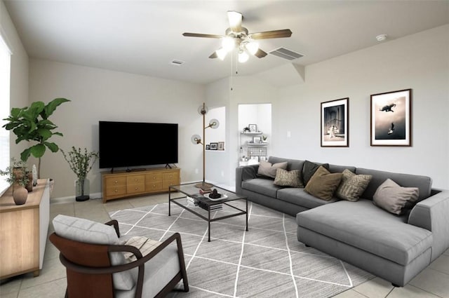 living room with light tile patterned floors, ceiling fan, visible vents, and baseboards