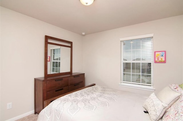 bedroom featuring baseboards and carpet flooring