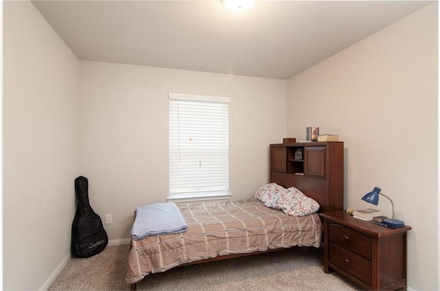 bedroom featuring carpet and baseboards