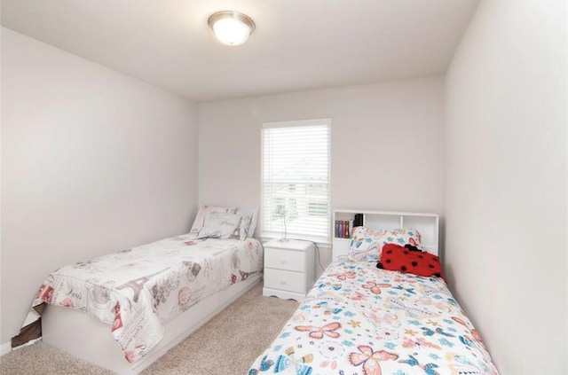 bedroom featuring light carpet