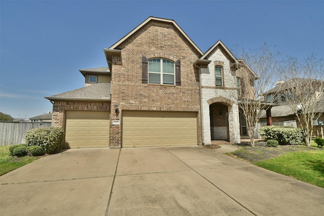 view of front facade featuring brick siding, a shingled roof, fence, concrete driveway, and an attached garage