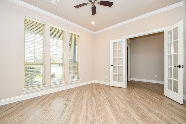 spare room featuring crown molding, baseboards, ceiling fan, light wood-type flooring, and french doors