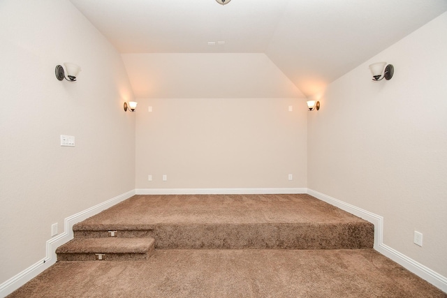 bonus room with carpet floors, baseboards, and vaulted ceiling