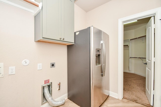 laundry room featuring cabinet space, electric dryer hookup, baseboards, and hookup for a gas dryer