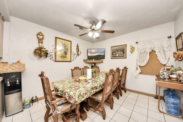 dining space with light tile patterned floors, a ceiling fan, and baseboards