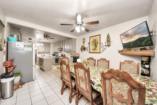 dining space with light tile patterned floors and a ceiling fan