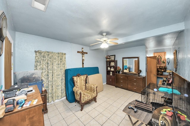 living area featuring a ceiling fan, visible vents, and light tile patterned floors