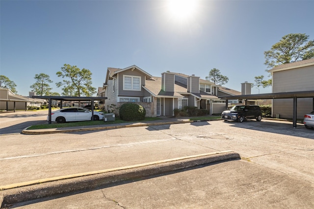 6341 Shadow Tree Dr, Houston, TX 77035 - view of property with covered and uncovered parking, a residential view, and stone siding