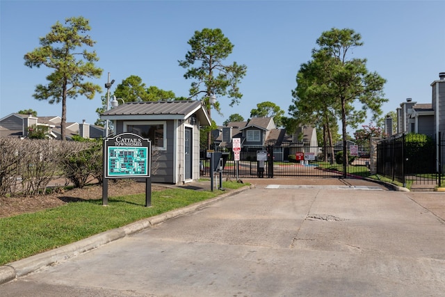 6341 Shadow Tree Dr, Houston, TX 77035 - view of concrete road with curbs, a gated entry, a residential view, and a gate