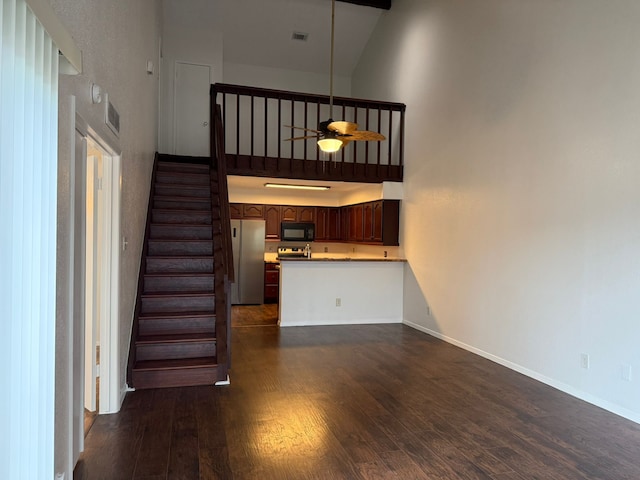 6341 Shadow Tree Dr, Houston, TX 77035 - unfurnished living room with a high ceiling, dark wood finished floors, stairs, and a ceiling fan