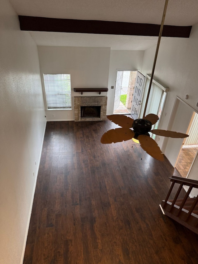 6341 Shadow Tree Dr, Houston, TX 77035 - living room with beam ceiling, wood finished floors, a brick fireplace, and a ceiling fan