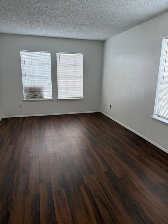 6341 Shadow Tree Dr, Houston, TX 77035 - spare room with dark wood finished floors, healthy amount of natural light, and a textured ceiling